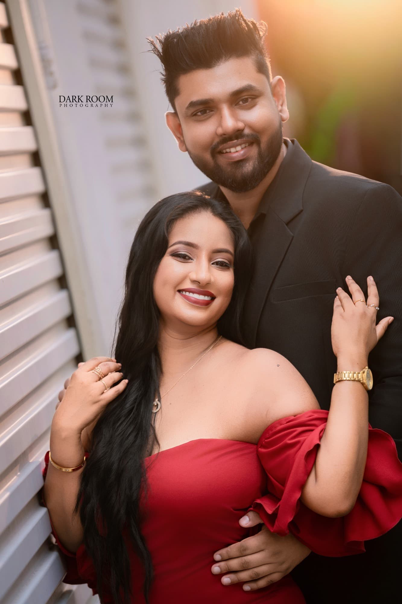 Ashan and Oshini smiling together in the golden evening light