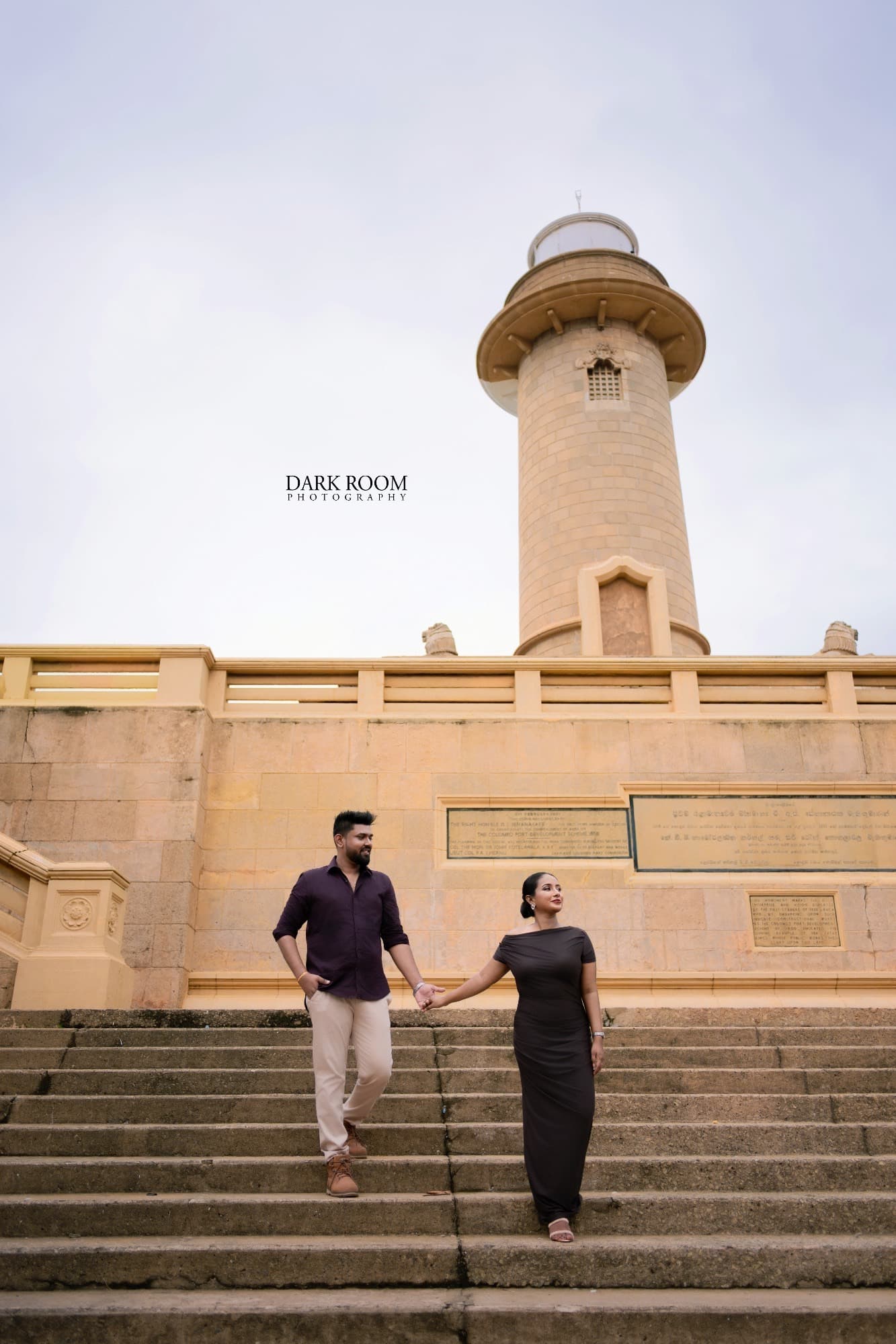 Ashan and Oshini walking hand in hand down the lighthouse steps