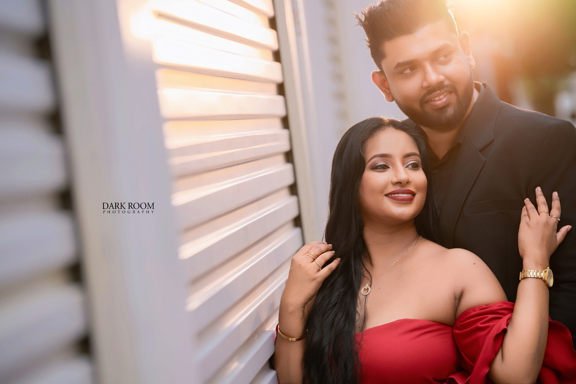 Ashan and Oshini by the white shutters in the golden evening light